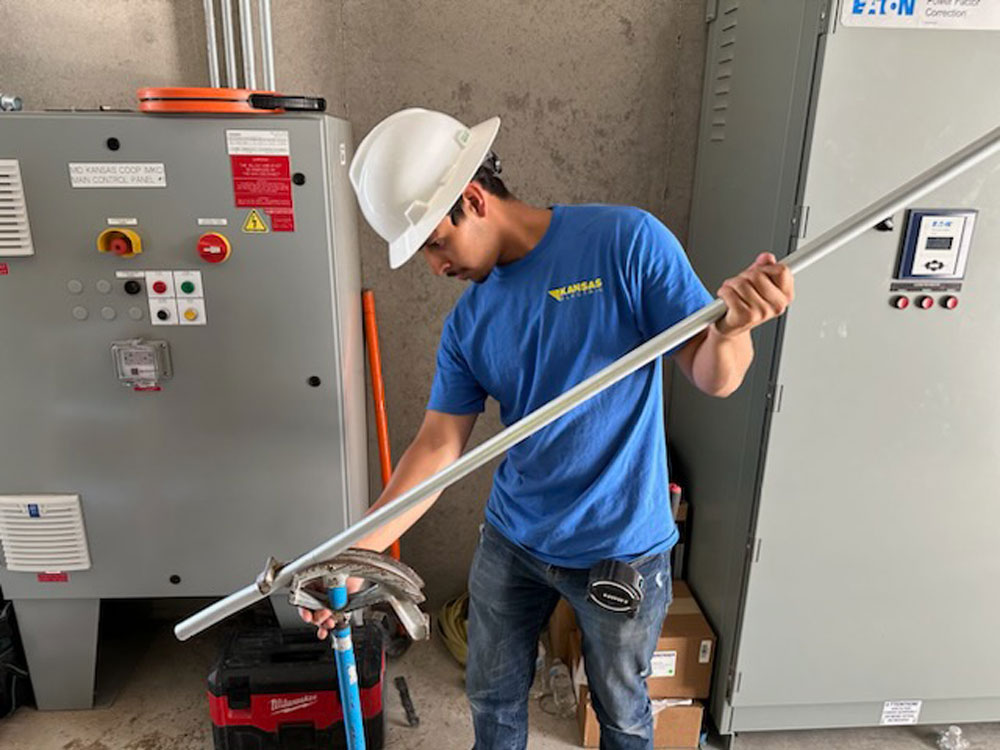 Electrician with an electician apprentice on a job site