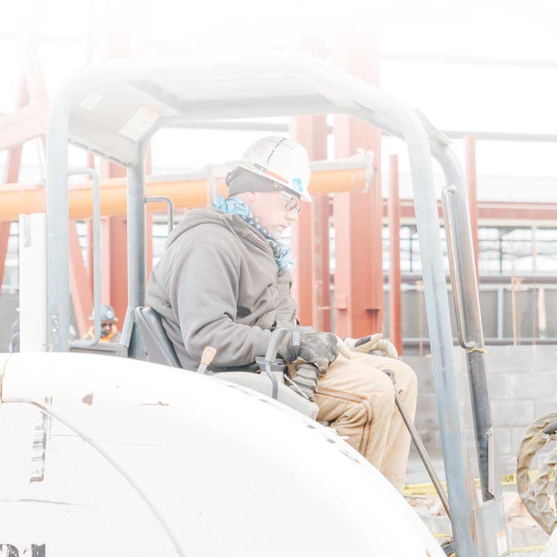 Kansas Electric employee driving a lift